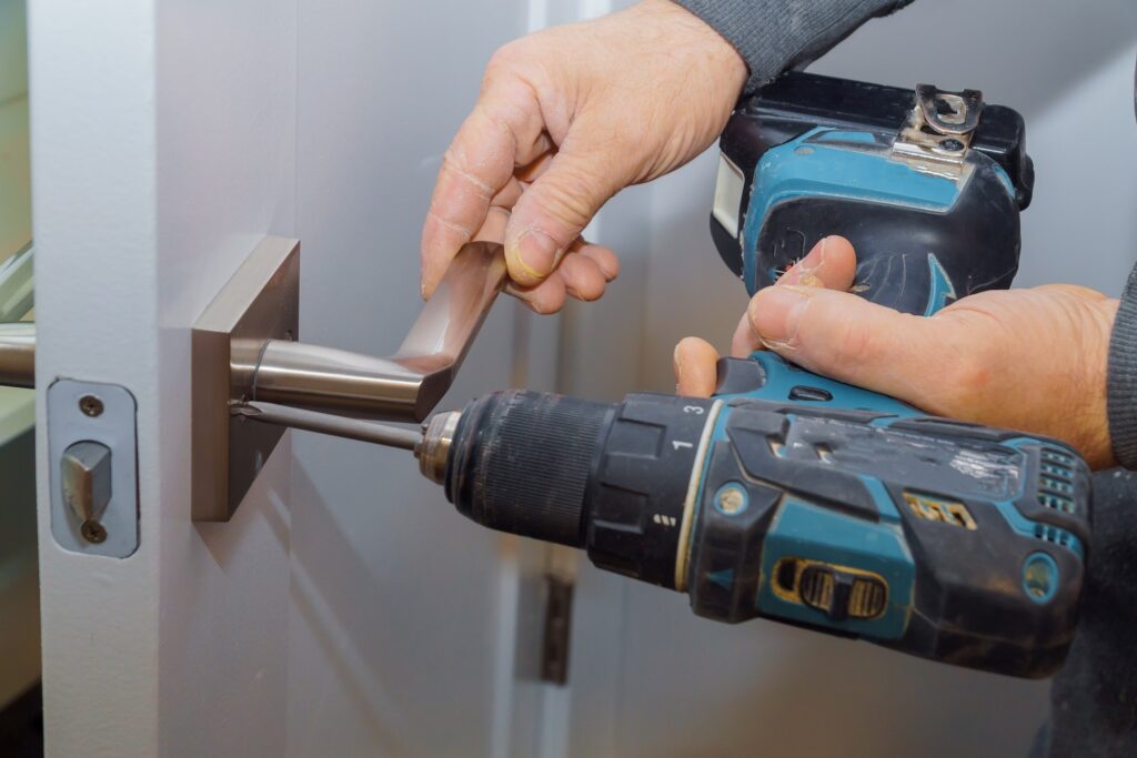 Installation locked interior door woodworker hands install lock Installation of the door lock.